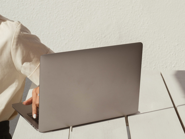 A person's shoulder and a laptop.